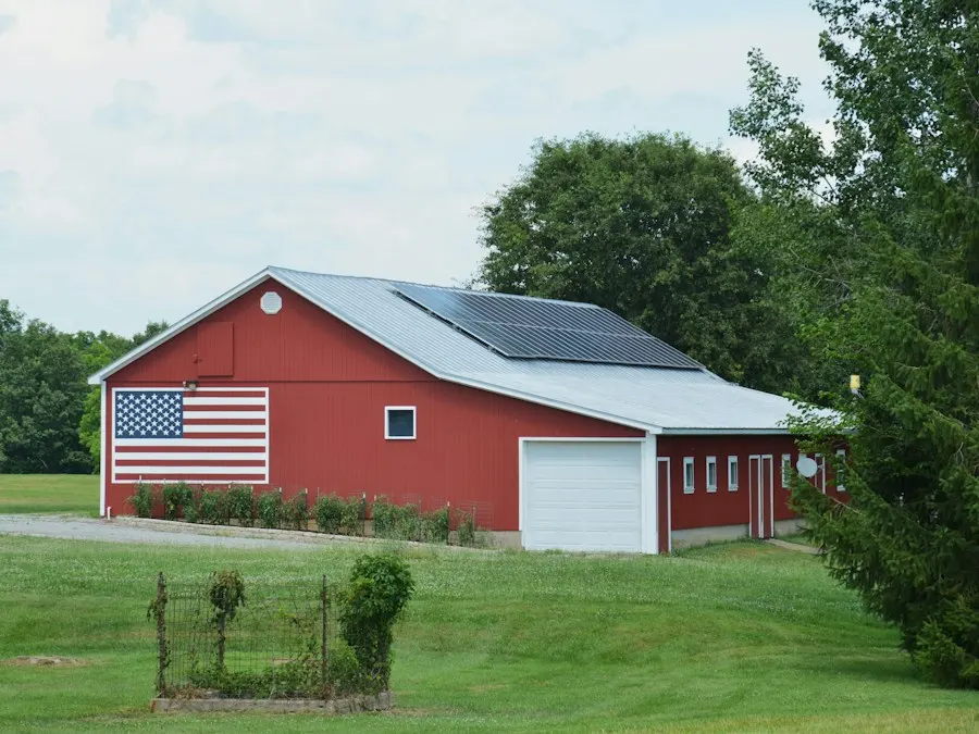 Red barn with an American flag and solar panels on its roof