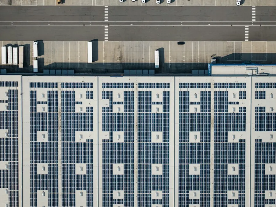 Aerial view of a warehouse roof covered in solar panels