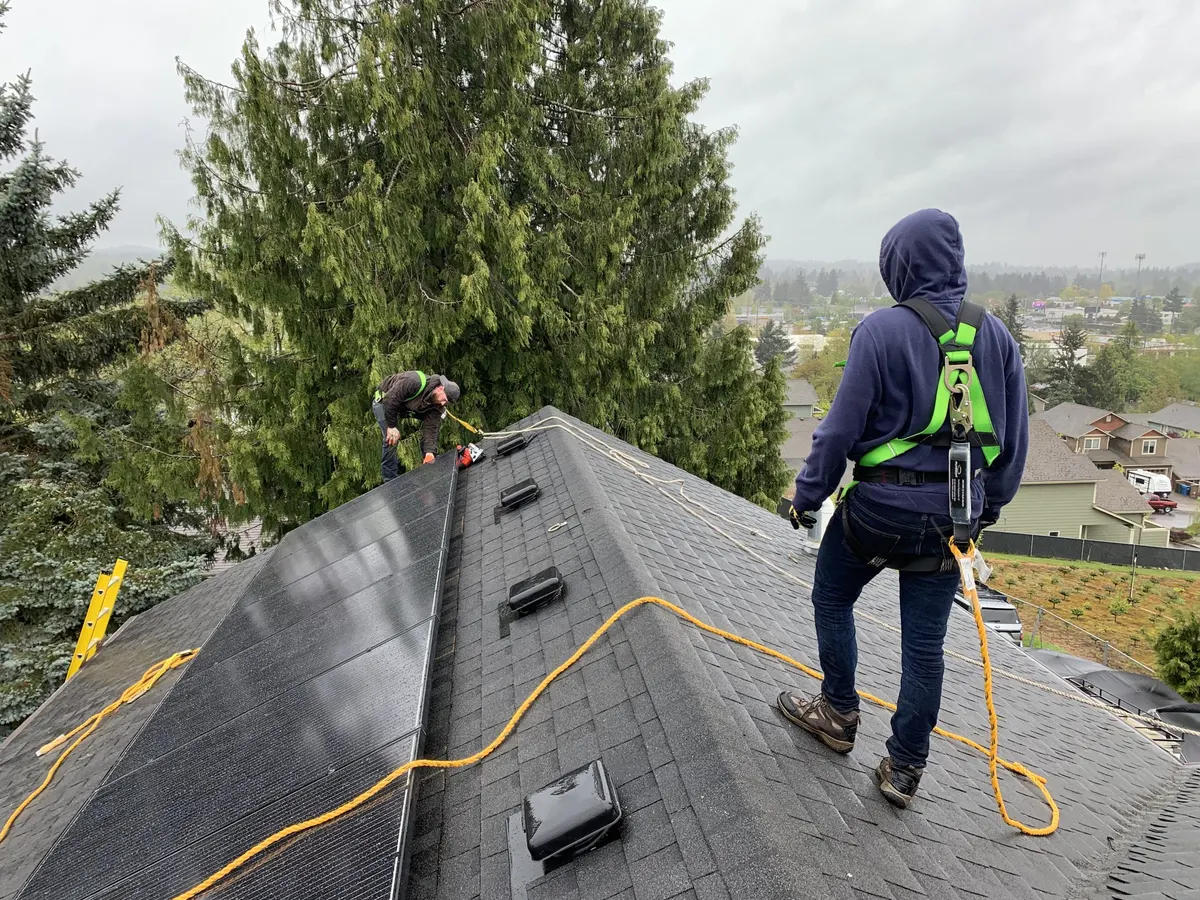 Sunward Power crew installing solar panels on a shingle roof