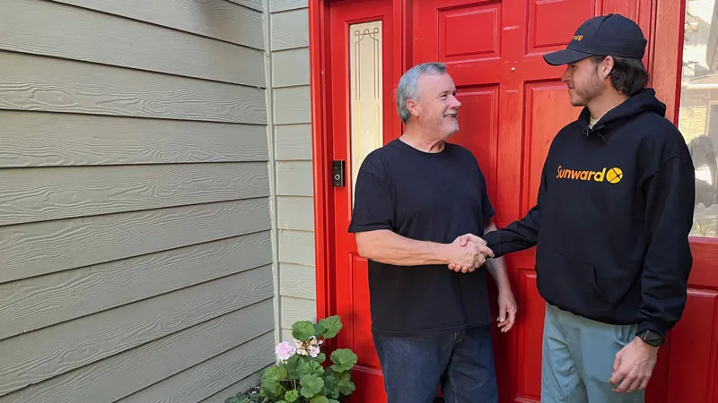 Sunward Power team member shaking hands with an Oregon homeowner at the front door
